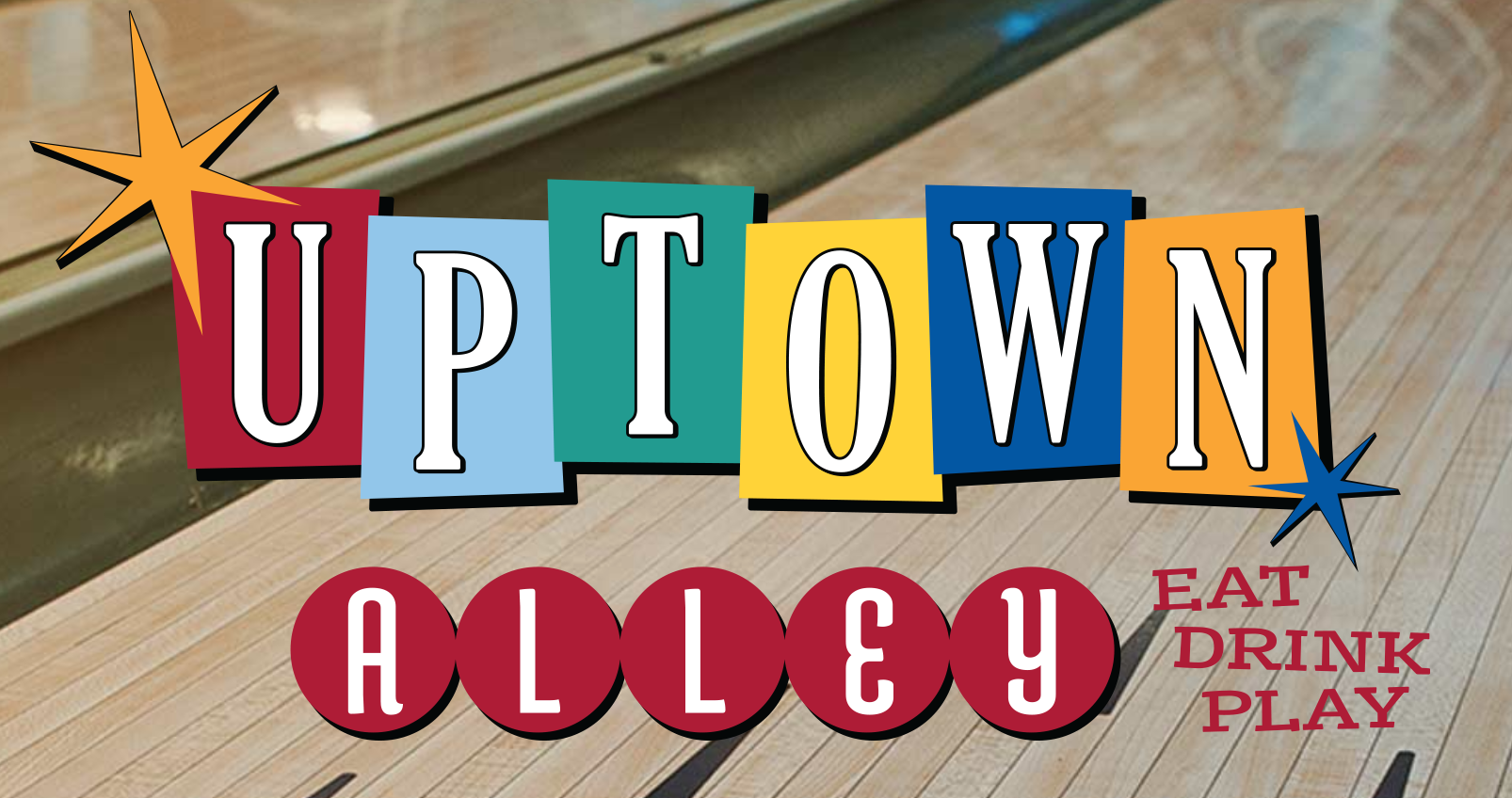 The logo for Uptown Alley. The design features a colorful and playful logo with each letter of "UPTOWN" displayed in individual squares of different colors: red, blue, teal, yellow, and orange. The letters are in white, bold, and stylized font. The word "ALLEY" is written below "UPTOWN" in white letters inside red circles. To the right of "ALLEY," the words "EAT DRINK PLAY" are displayed in red.